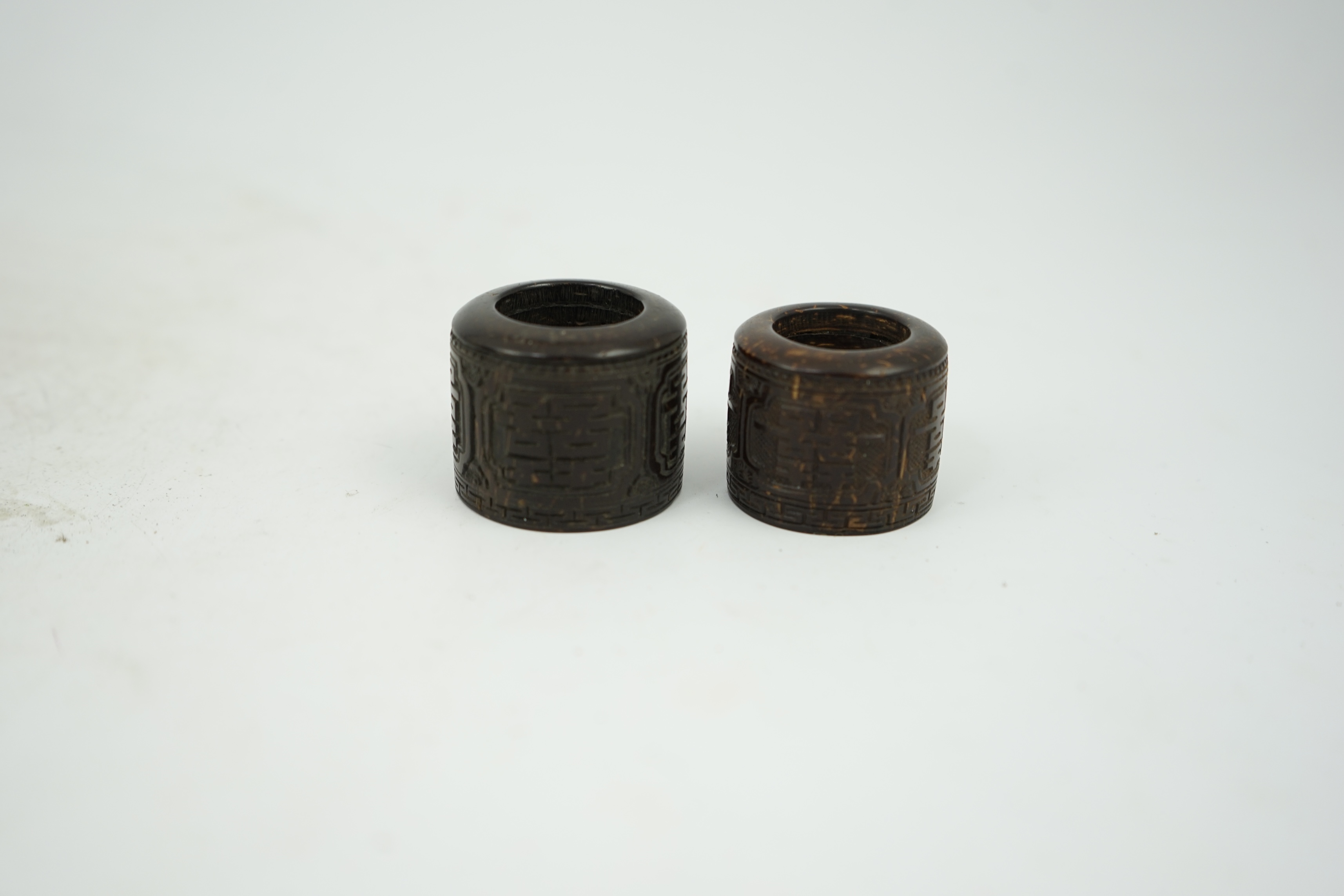 A pair of rare Chinese Straits palm wood archer's thumb rings, 19th century